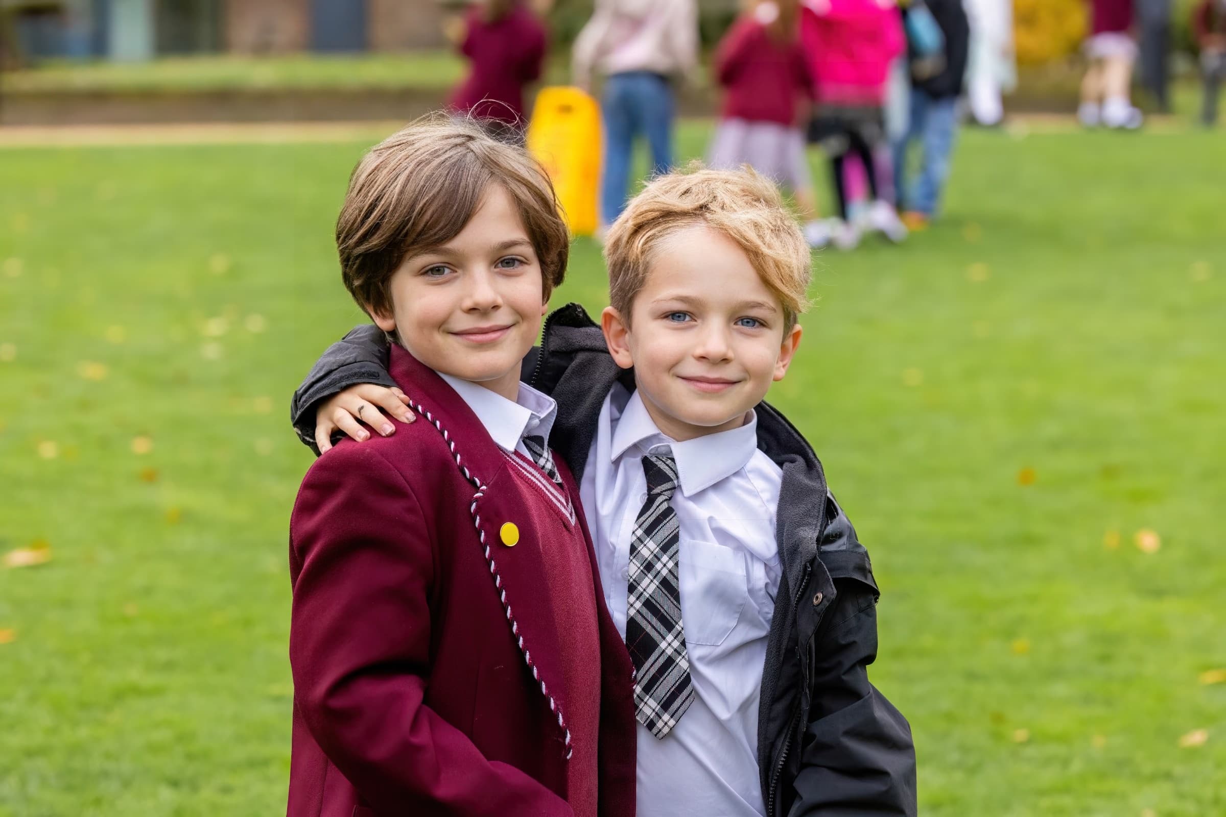 Public-facing version of the same school-grounds photo with the setting preserved and the pupils anonymised.